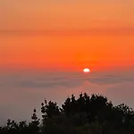Tiny House With Sunset Over The Ocean