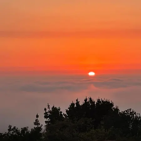 Tiny House With Sunset Over The Ocean